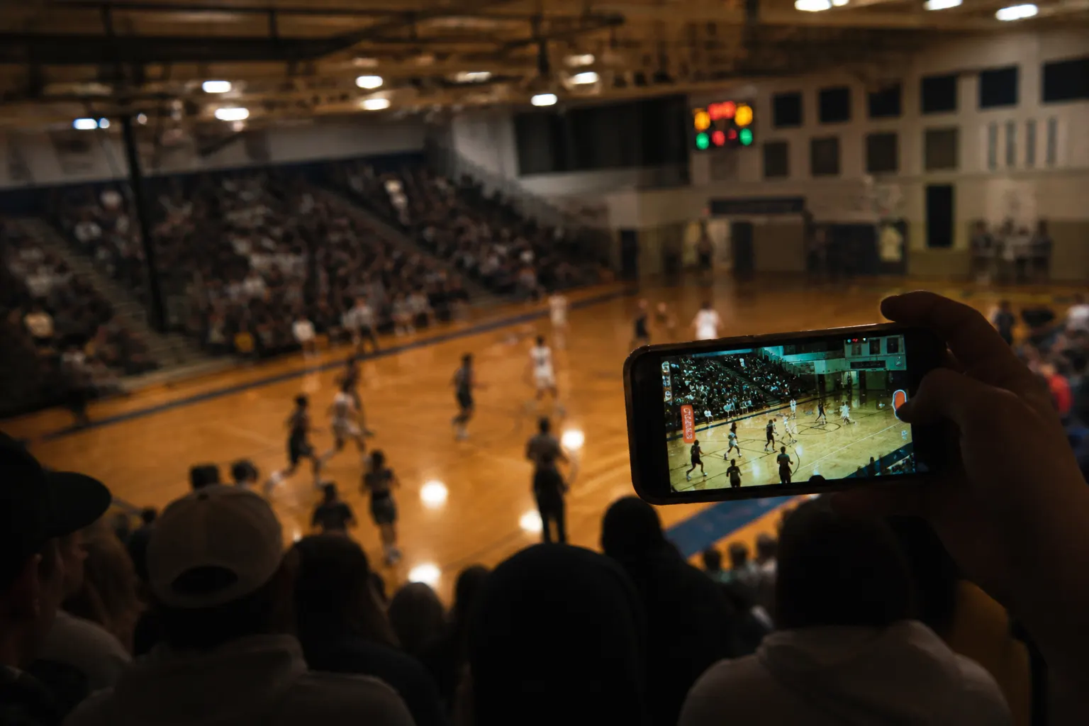 A wobbly, zoomed iPhone clip shot from the bleachers — the kind of bleacher film ScreenAssist tags.